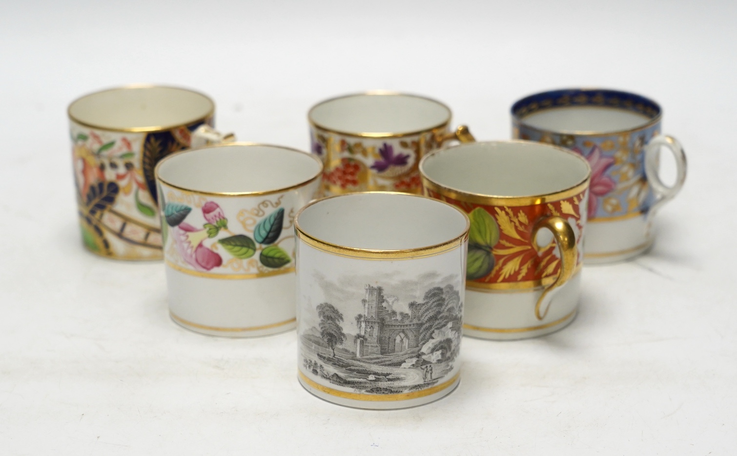 A group of twelve early 19th English porcelain coffee cans